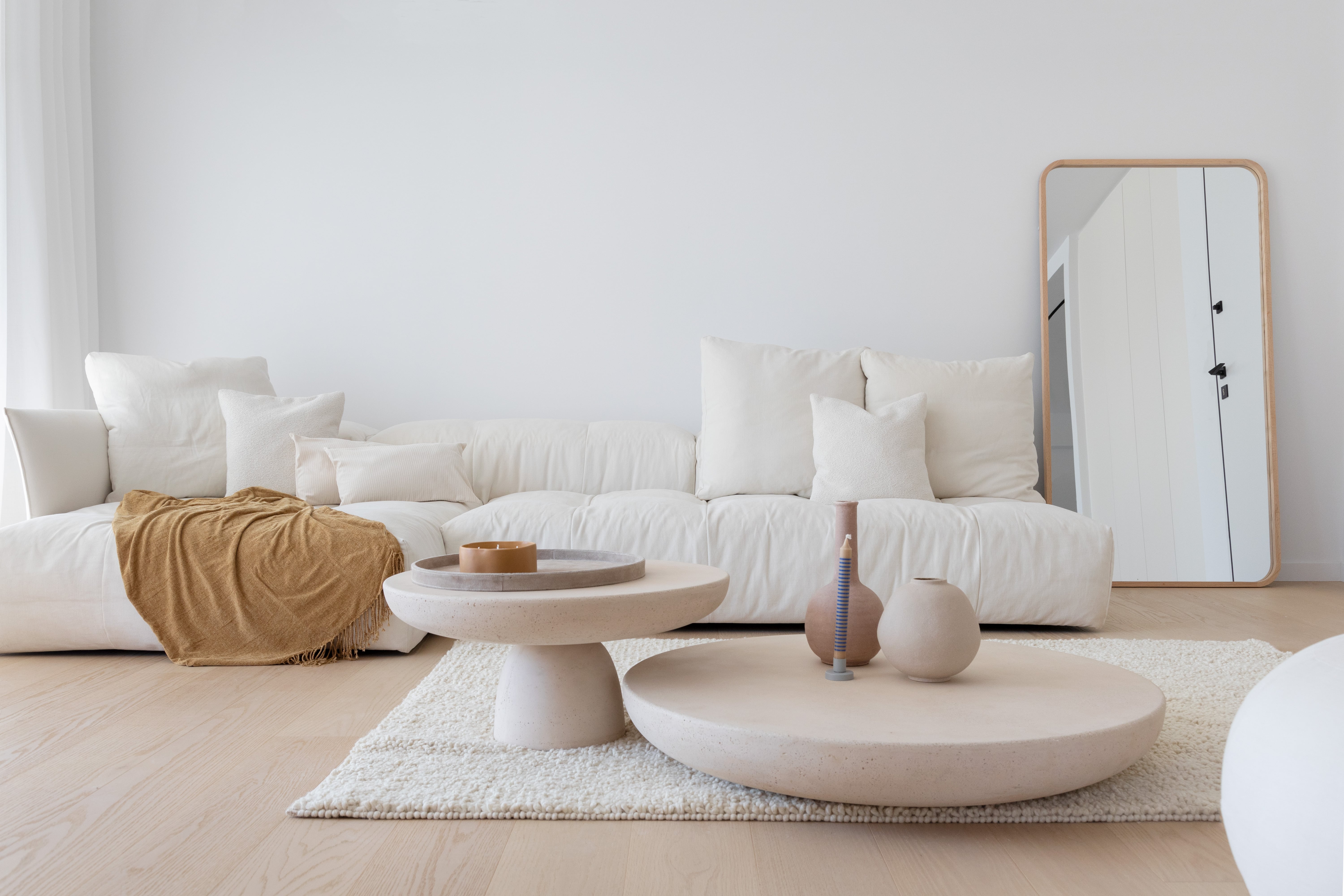 living room with white sofa and circular tables
